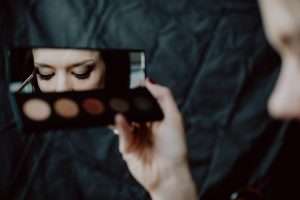 Woman applying dark eyeshadow